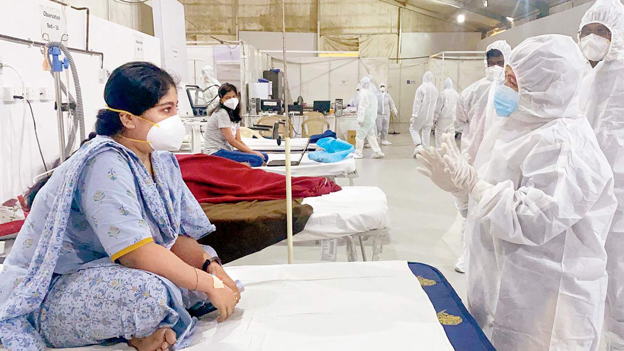 Mayor Kishori Pednekar, in PPE suit, speaks to a Covid patient, at BKC Jumbo Covid Care Centre, on Saturday. Pic/ANI