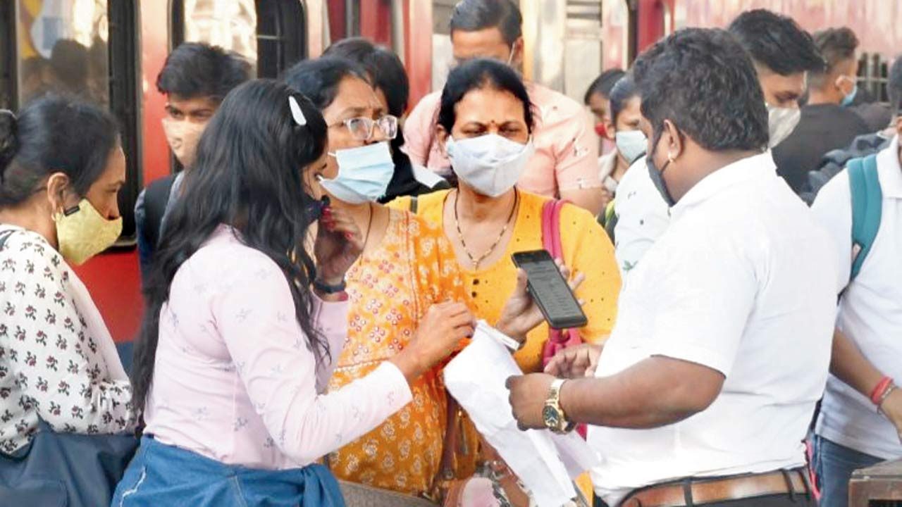 Passengers show their Covid vaccination certificate upon arrival at Dadar station, on Sunday. Pic/Ashish Raje