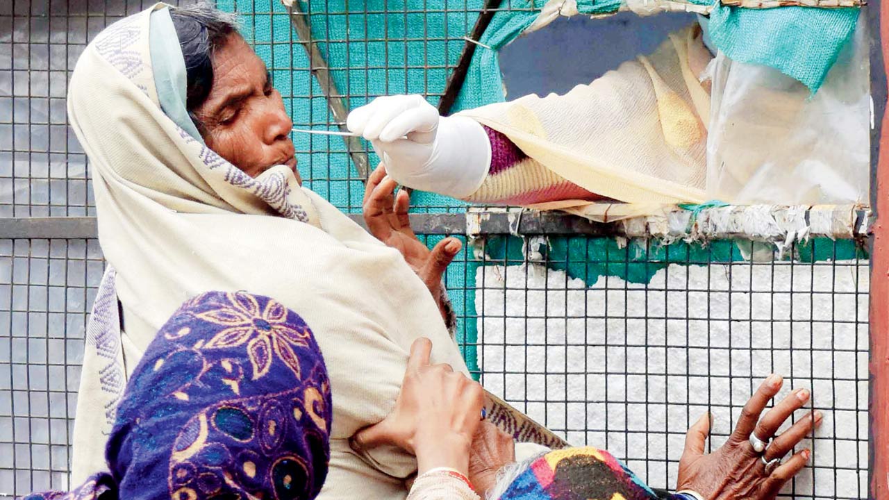 A health worker collects a sample in Prayagraj on Thursday. Pic/ANI