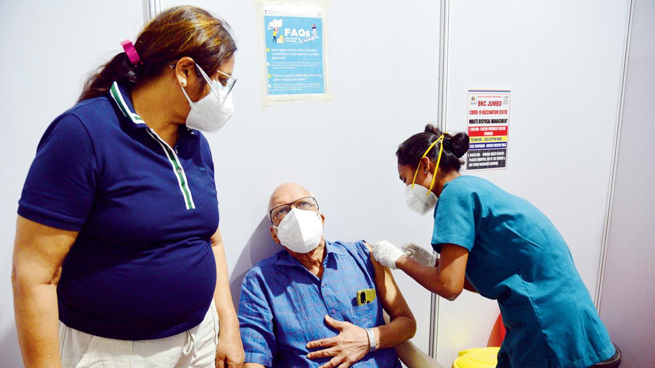A senior citizen gets a booster dose at BKC centre on Monday. Pic/Pradeep Dhivar