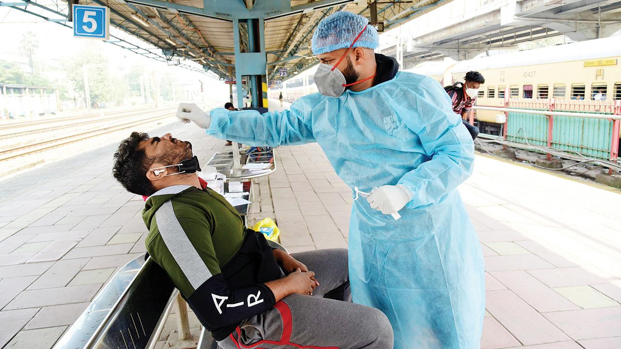 A BMC worker takes a sample at Dadar on Tuesday. Pic/Suresh Karkera