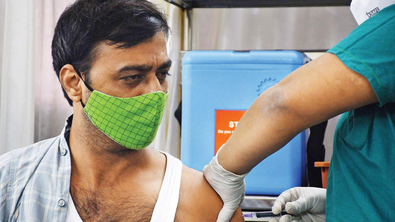 A genuine beneficiary gets a dose of COVID vaccine at Nair hospital on Thursday. Several unvaccinated people are rushing to get vaccination certificates through unscrupulous means as the documents are required to use several amenities, including the local trains, in the city. Pic/Ashish Raje