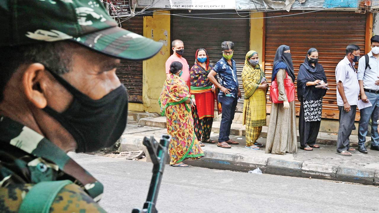 People queue outside a polling station in Kolkata in 2021. Pic/AFP
