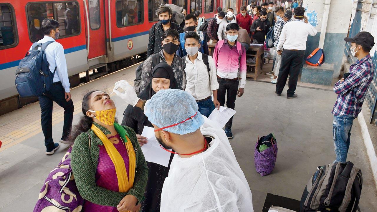 A passenger is tested at Dadar station on Wednesday. Doctors, experts urge people to rely on RT-PCR tests instead of home-test kits. Pic/Ashish Raje