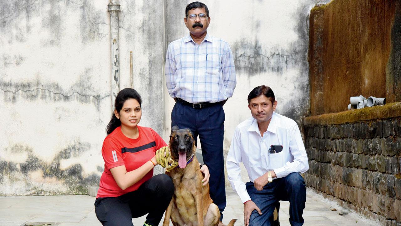 Jessy with her handler and officers from the dog squad