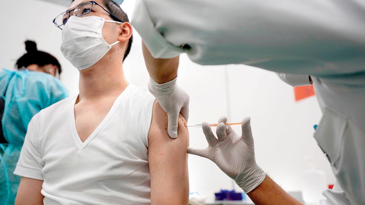 A medical worker receives his third dose of the Pfizer COVID-19 vaccine at a vaccination centre on January 6 in Tokyo. Pics/AP