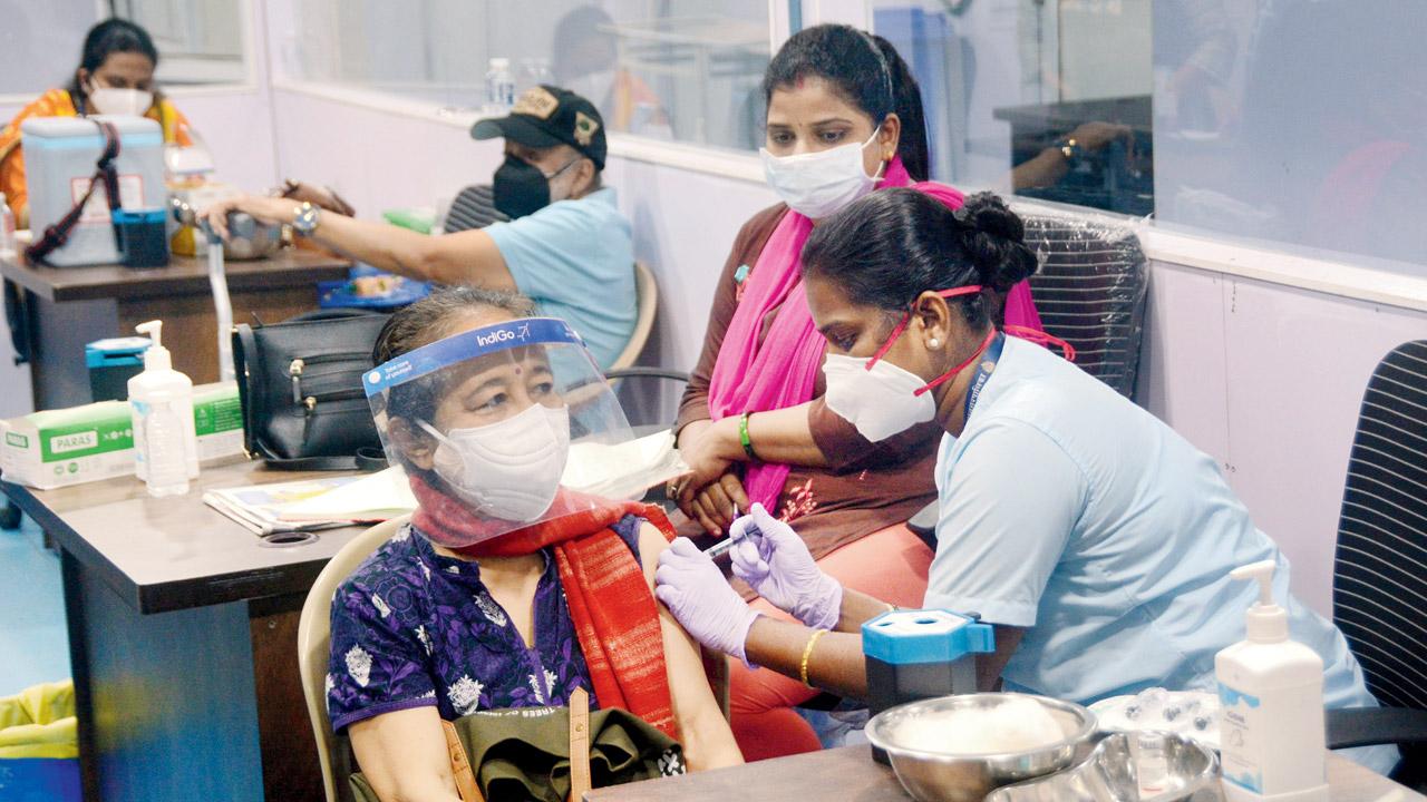 An elderly woman gets her booster shot, at Dedicated Covid Health Centre in Kanjurmarg East. File pic