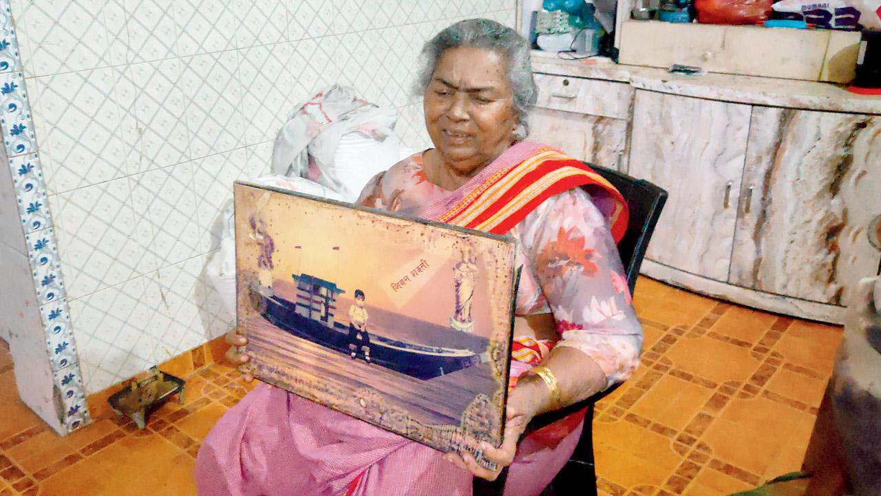 Philomina Chinchak holds on to the photo of her boat, Jeevanshakti, which was completely destroyed in the storm