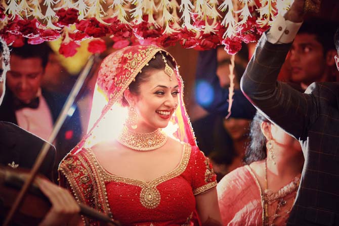 Divyanka chose a red and gold lehenga for the occasion and her jewellery, apparently from a brand she used to endorse at that time, complemented the attire perfectly. The groom, Vivek, matched his sherwani with the bride's trousseau.
In picture: Divyanka Tripathi at her wedding ceremony