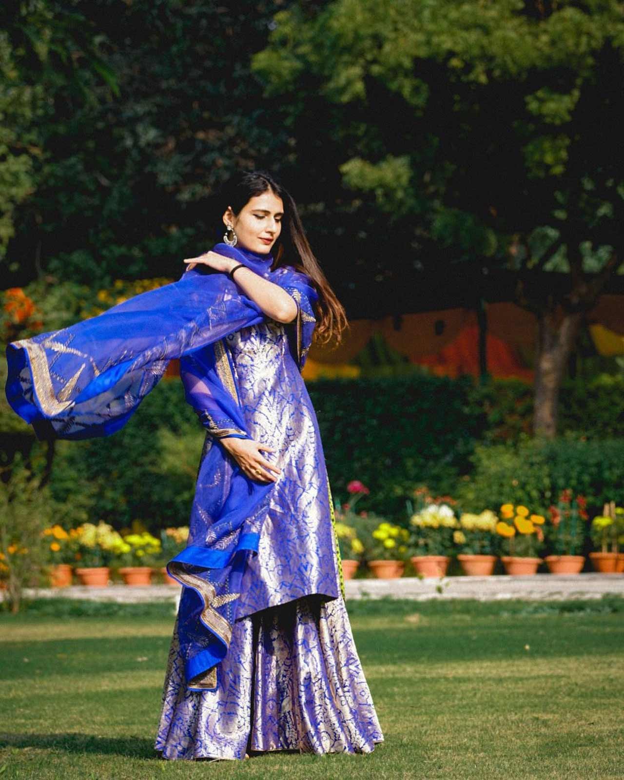 Girls looking forward to a comfortable yet vibrantly chic ethnic look can go for a traditional sharara suit paired with a matching dupatta. This blue ensemble from Fatima's wardrobe will make your heads turn at first sight. You can copy her ensemble and slay in this Indian outfit.