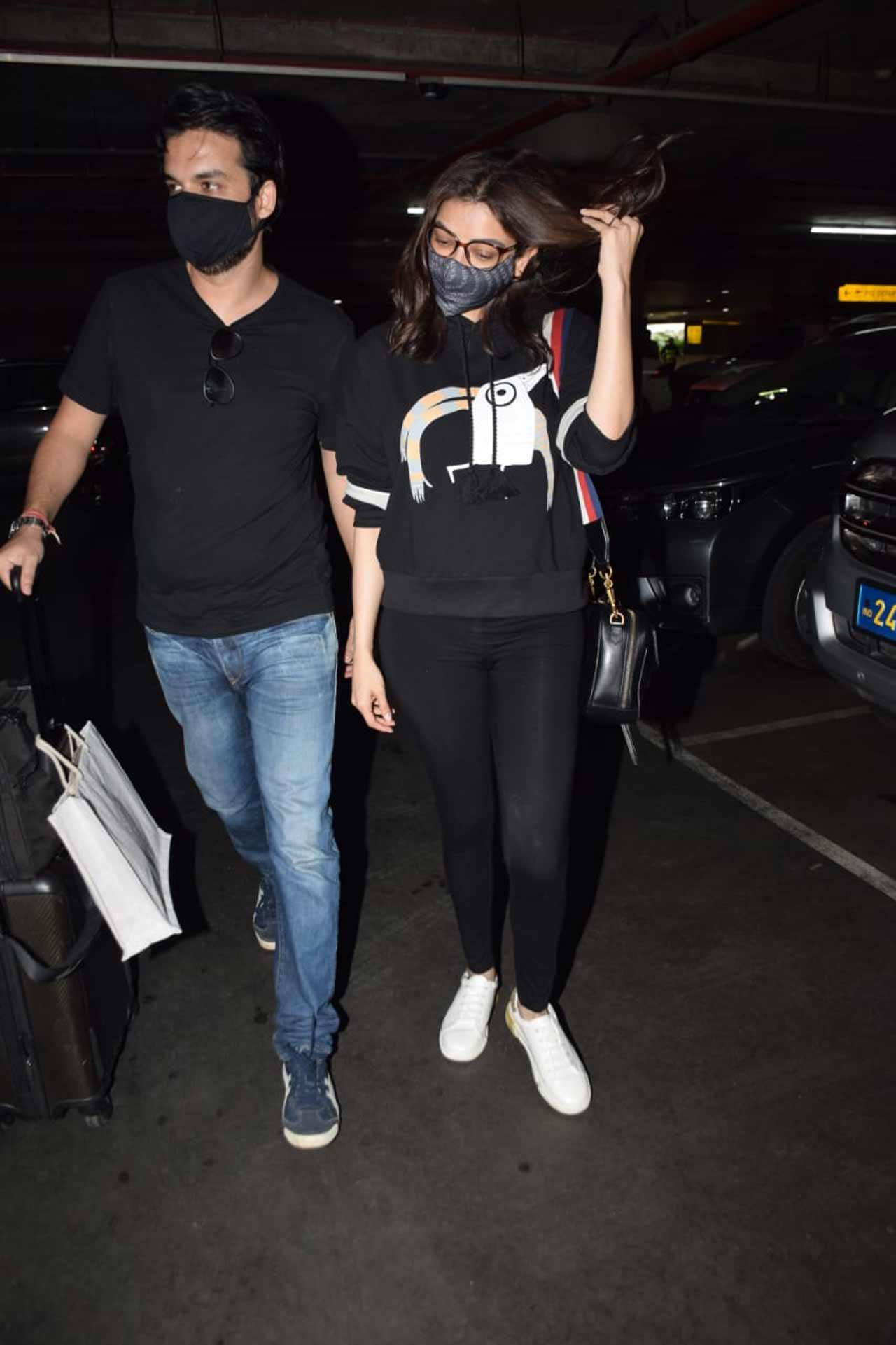 Kajal Aggarwal and her husband Gautam Kitchlu were snapped together at the Mumbai airport. Kajal Aggarwal is expecting her first child, as confirmed by her businessman Gautam Kitchlu on social media.