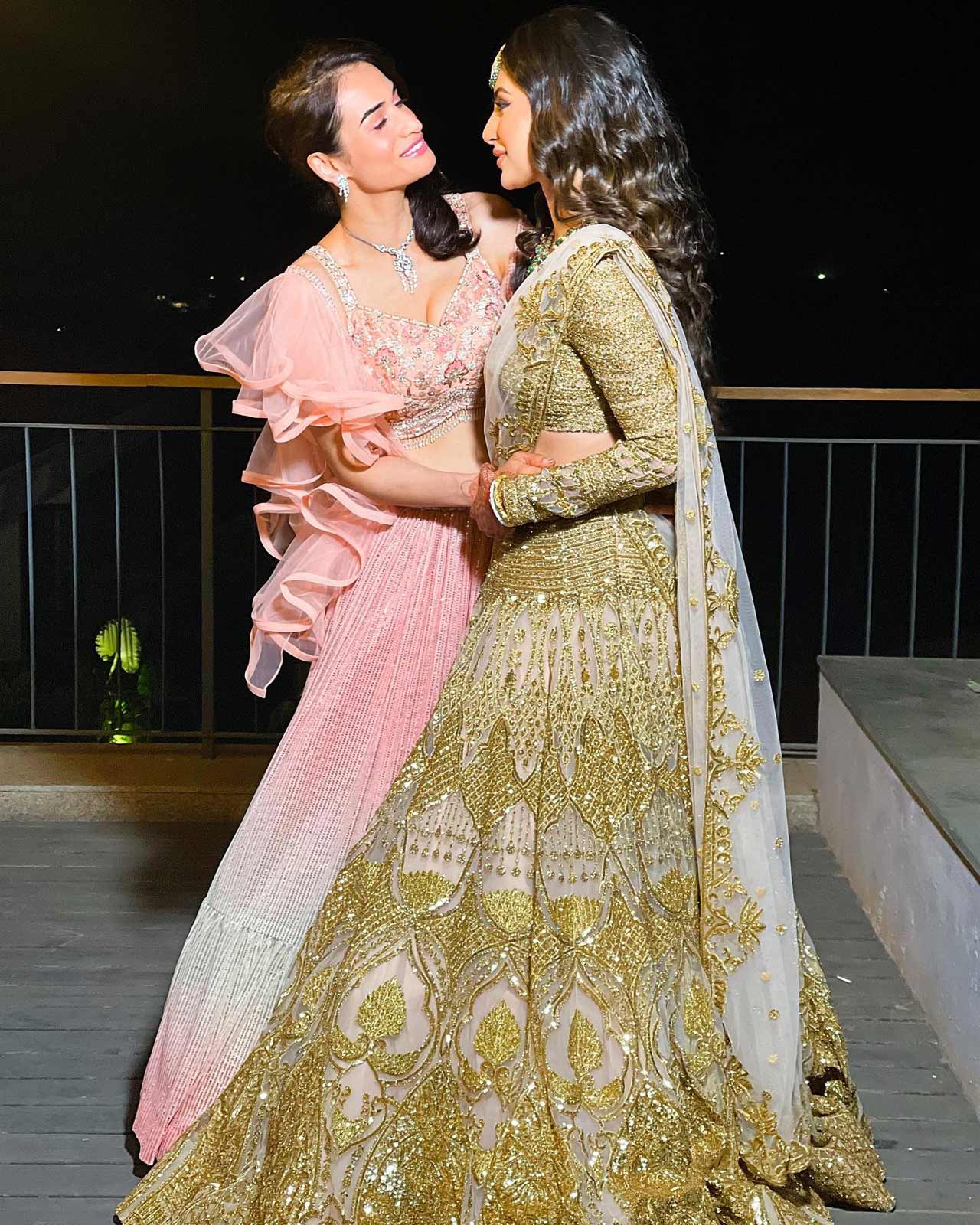 For their shimmery Sangeet night, the bride wore a heavy golden lehenga with emerald jewellery. Suraj looked dapper in a royal blue sherwani, as seen in their cake cutting and dance videos on social media.