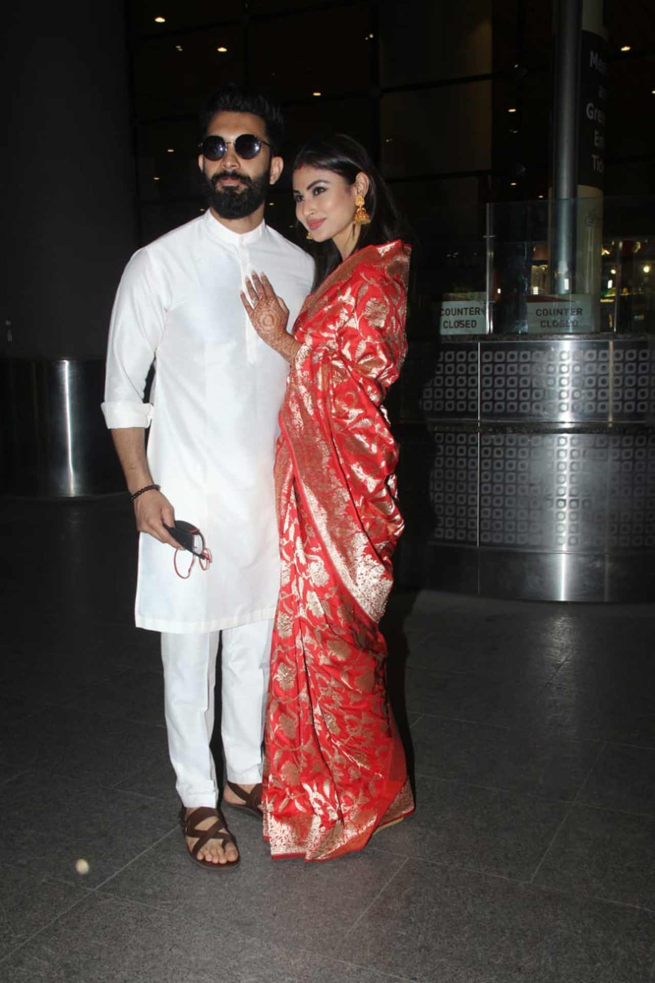 Mouni stunned in a white saree, whereas the groom, who opted for a South inspired ensemble - a beige coloured kurta, paired with a lungi, showed off his uber-cool side in this simple outfit for their first wedding which followed all South Indian traditions.