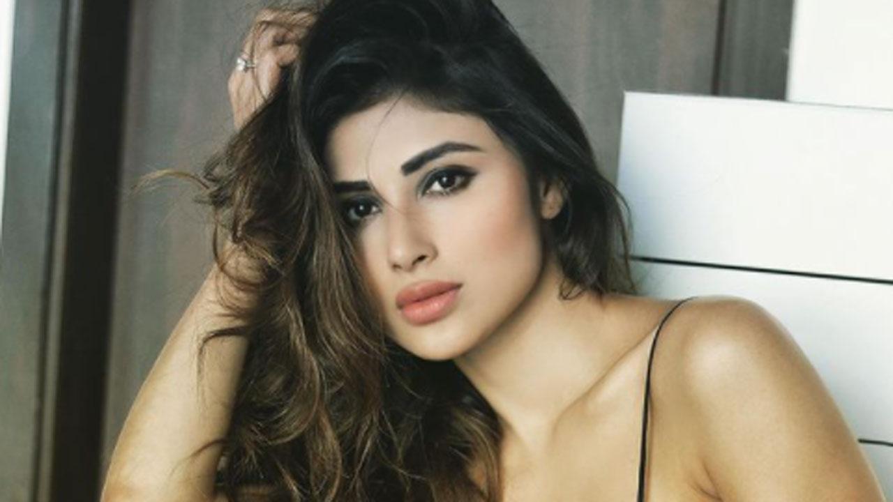 Mouni Roy reacts as a photographer congratulates the actress for her wedding