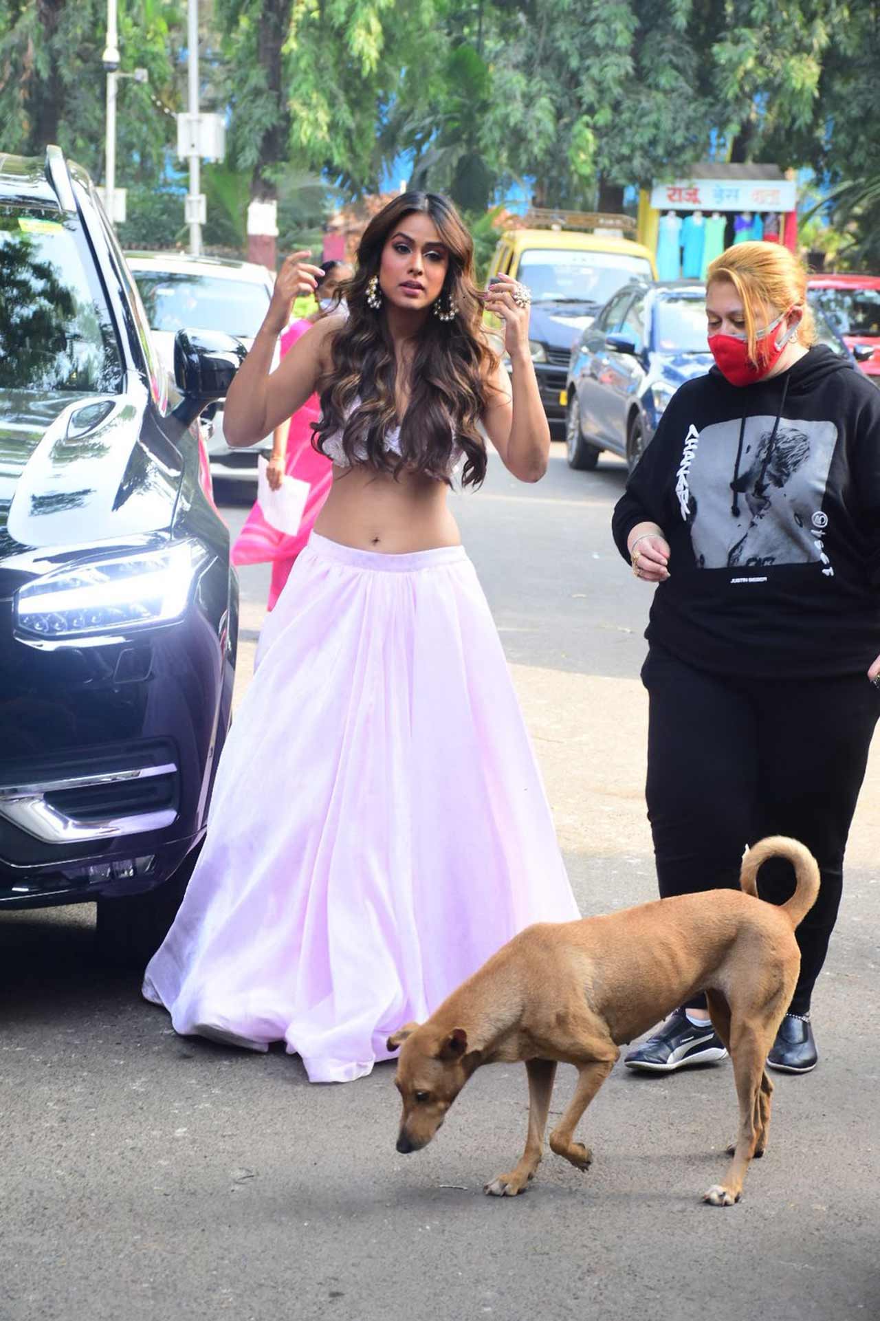 Nia Sharma was caught off guard as she was seen promoting her upcoming song 'Phoonk Le' in Mumbai city. The popular television actress was seen wearing a white lehenga for the event.