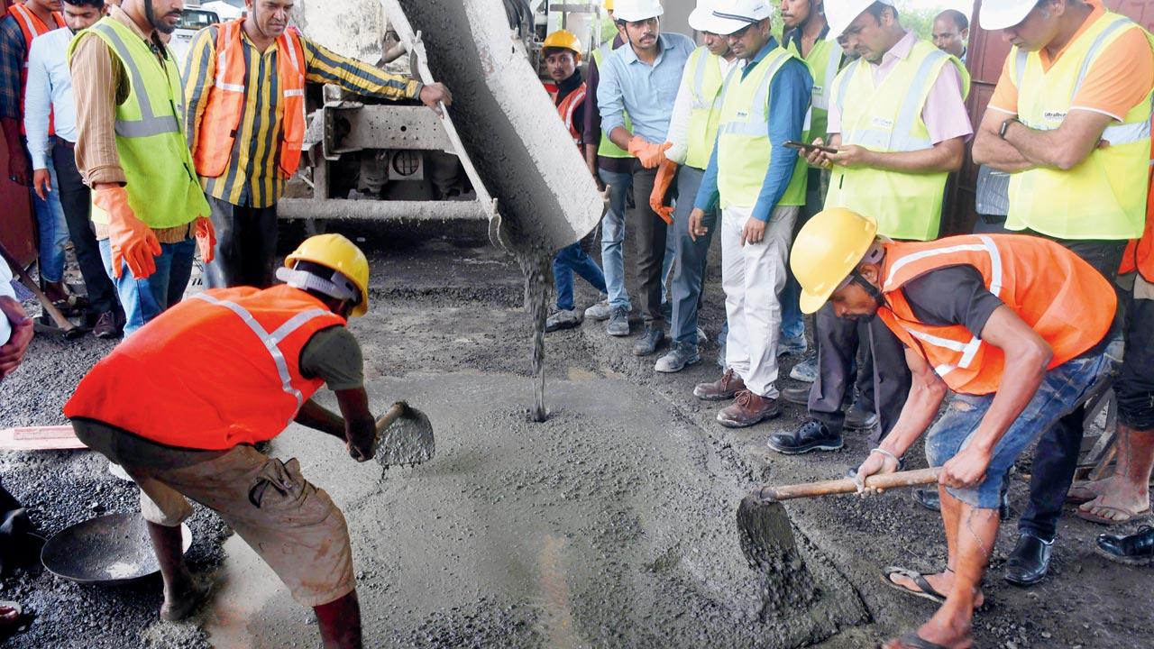 A pothole being sealed with rapid hardening concrete, near Dayshankar Chowk on July 22. Pic/Ashish Raje