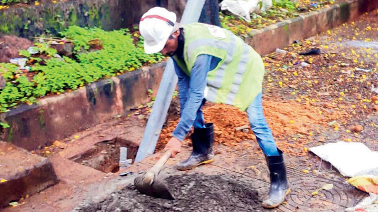 A light pole being installed at the open plot at Navagaon, Dahisar West. Schoolkids play in the ground in the morning
