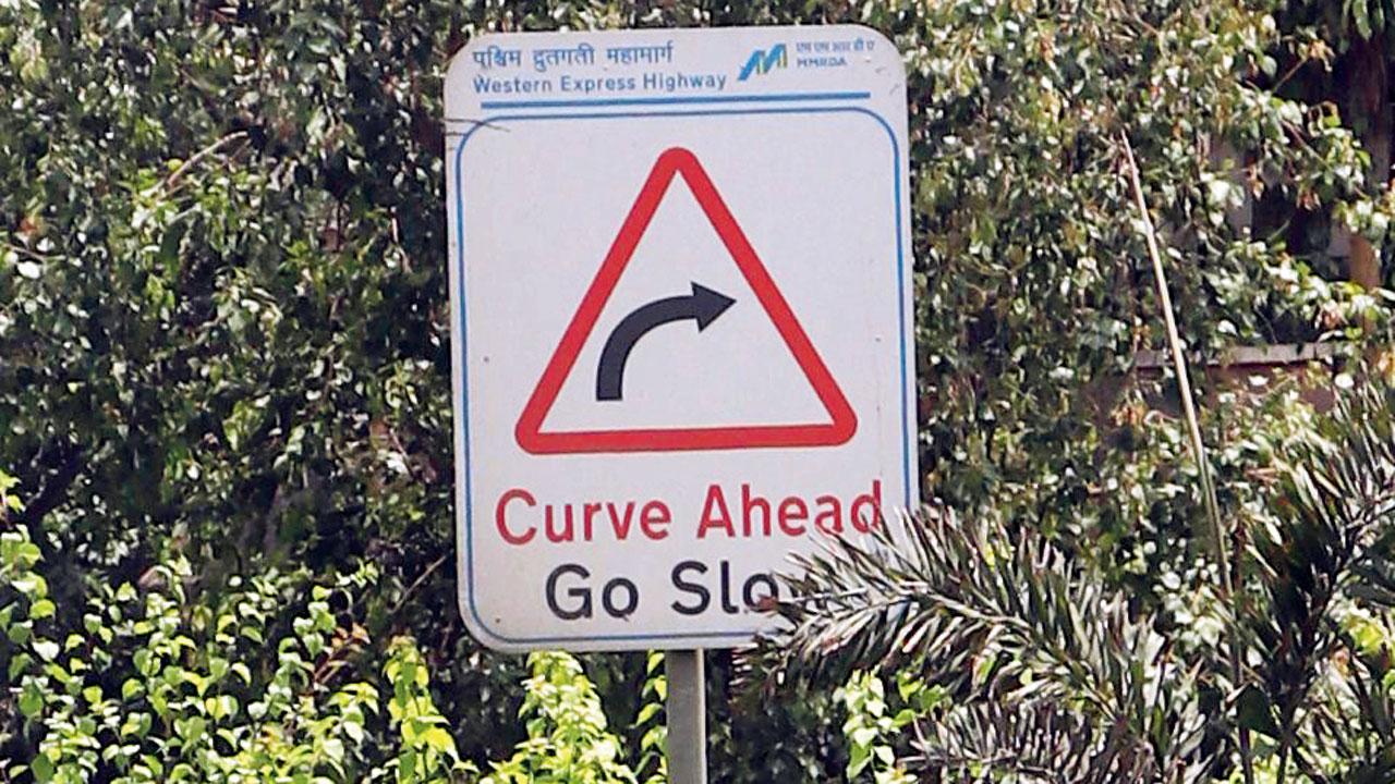 A signage warning motorists of a curve ahead on Western Express Highway, Kandivli East