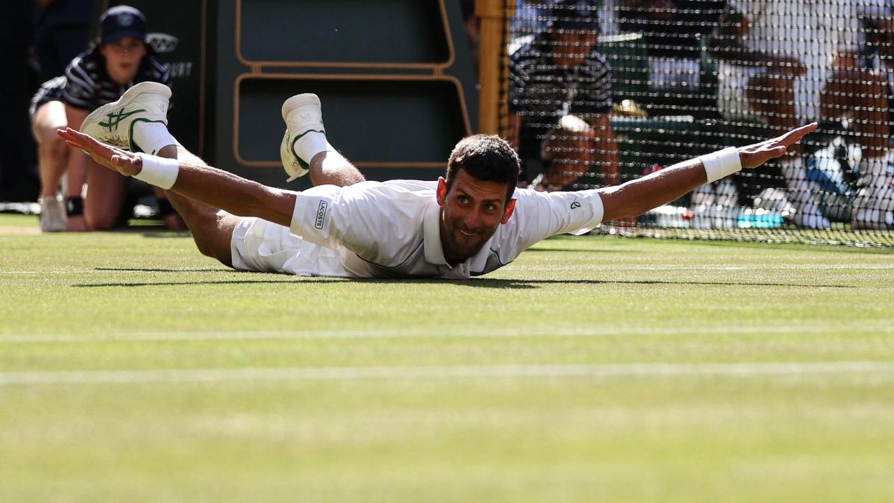The grandest part of Novak's otherwise subdued title celebrations was him lying on his belly with his arms outstretched