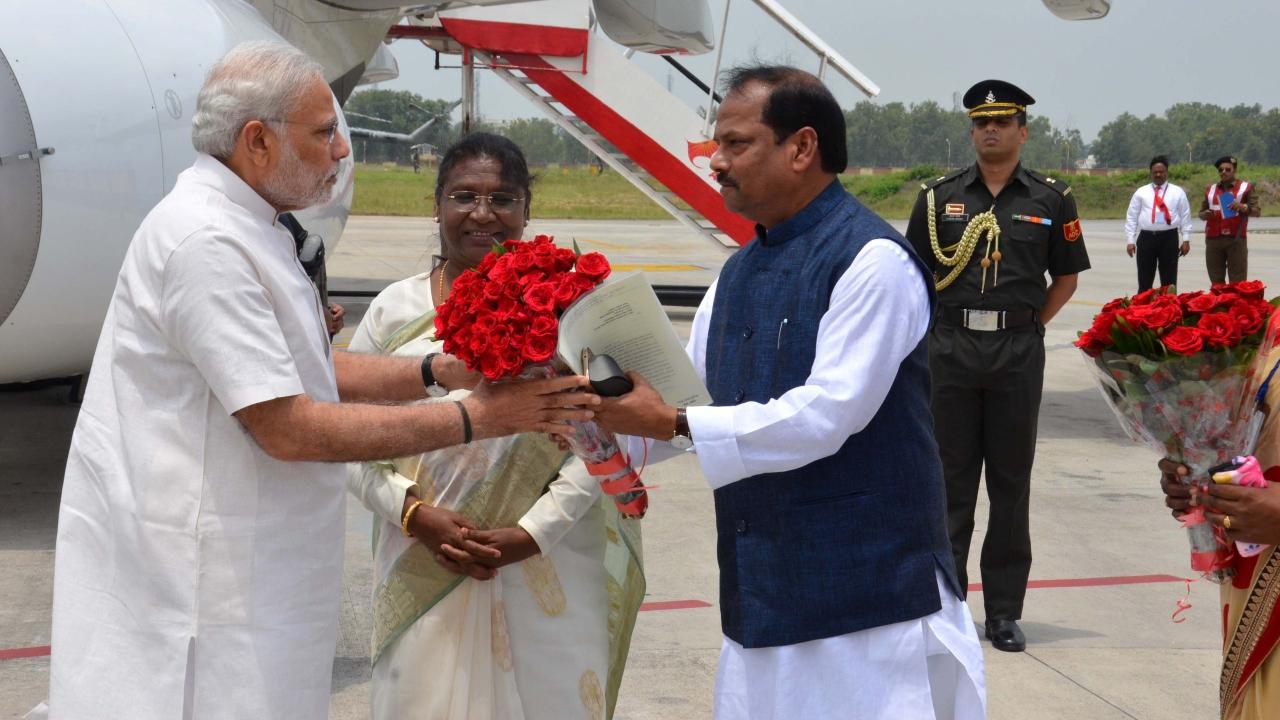 Prime Minister Narendra Modi is received by Draupadi Murmu and Raghubar Das, Chief Minister of Jharkhand at Birsa Munda International Airport in Ranchi on June 28, 2015. Murmu was then the Governor of Jharkhand.  Pic/AFP