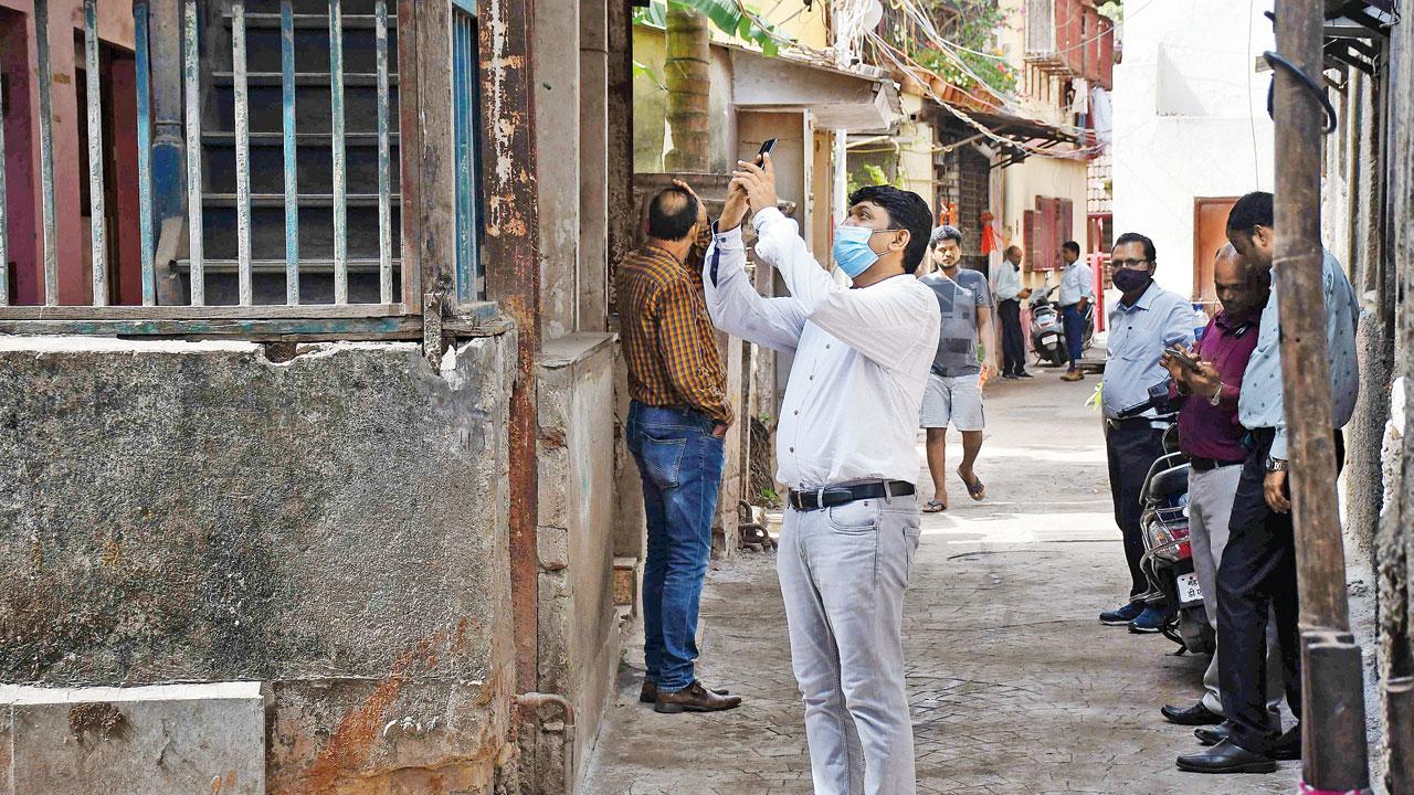 A BMC official inspects the bungalow on May 24