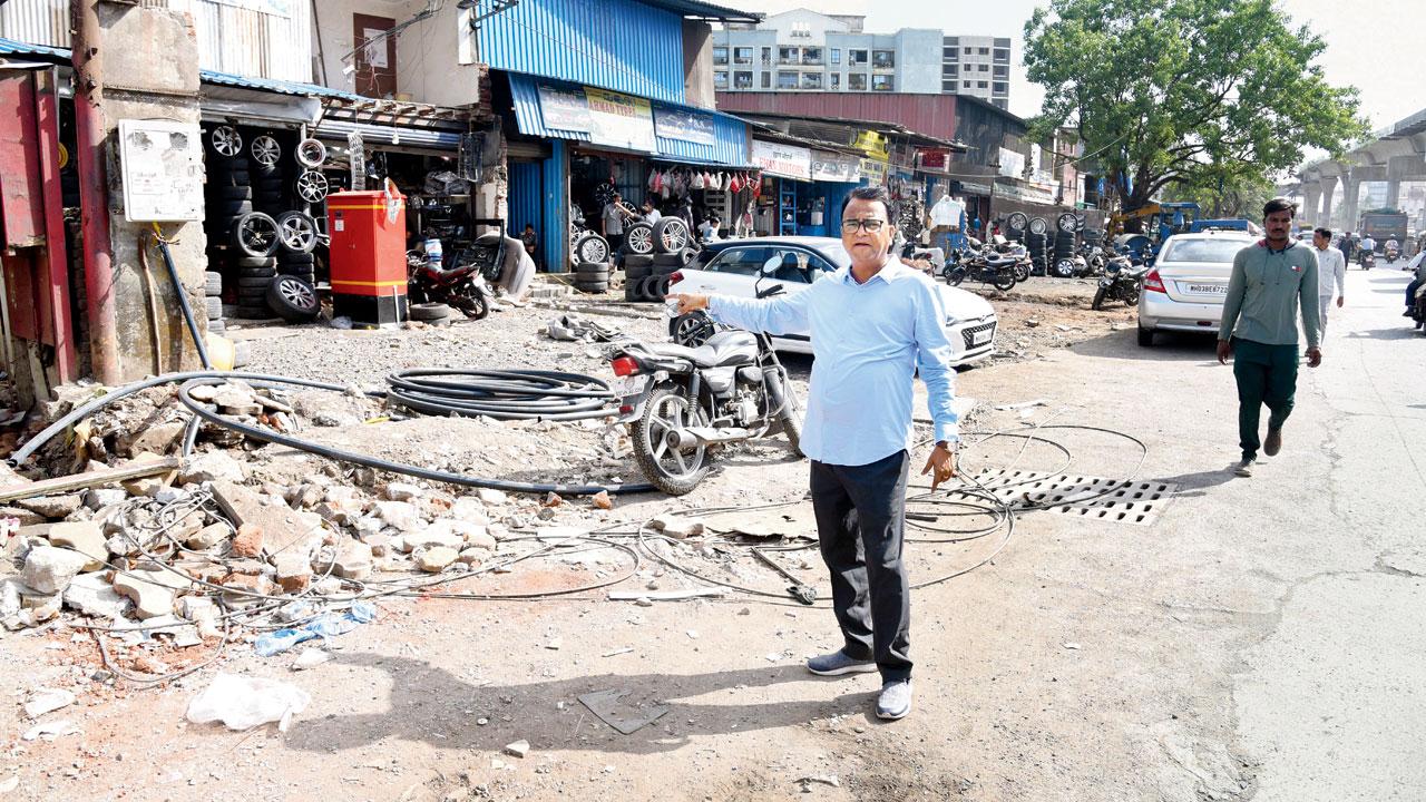 Kurla resident Ajay Shukla points to an encroached footpath on CST Road. Pic/Sameer Markande