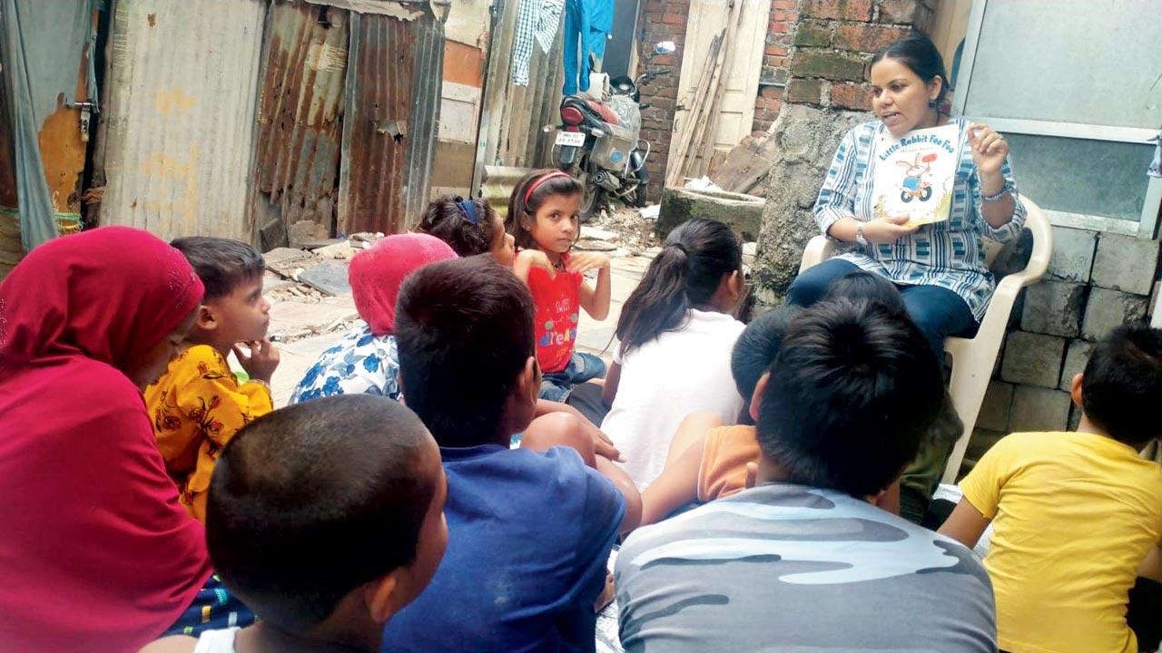 Darpana D Choudhary conducts a story-telling session in the lane running through the slum