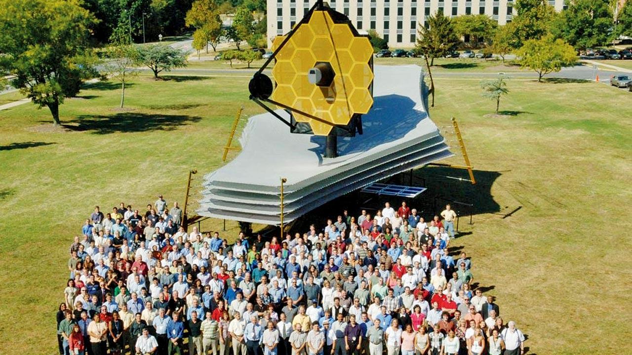 The James Webb Telescope team standing in front of the full scale telescope model at the Goddard Space Flight Centre in Maryland