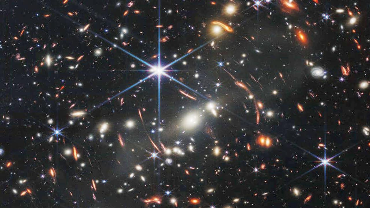 Deepest and sharpest infrared image of the distant universe to date. Known as Webb’s First Deep Field, this image of galaxy cluster SMACS 0723 is overflowing with detail. Thousands of galaxies—including the faintest objects ever observed in the infrared—have appeared in Webb’s view for the first time. This slice of the vast universe covers a patch of sky approximately the size of a grain of sand held at arm’s length by someone on the ground