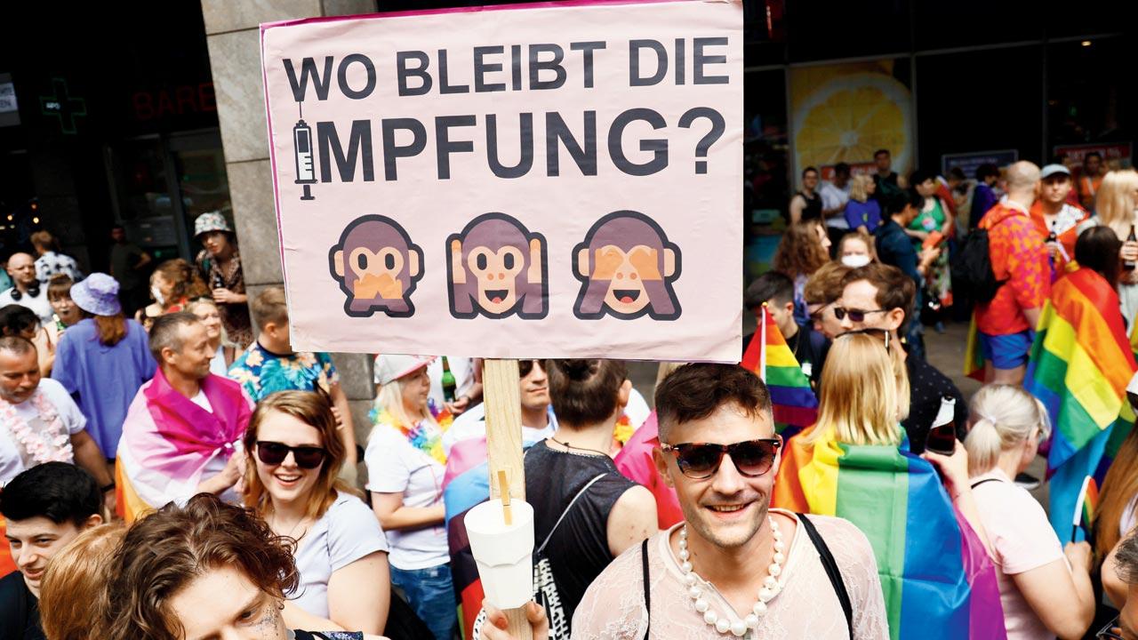 A man holds a banner reading ‘Where is the vaccination?’ during Christopher Street Day demonstration in Berlin, an annual European LGBTQiA+ celebration