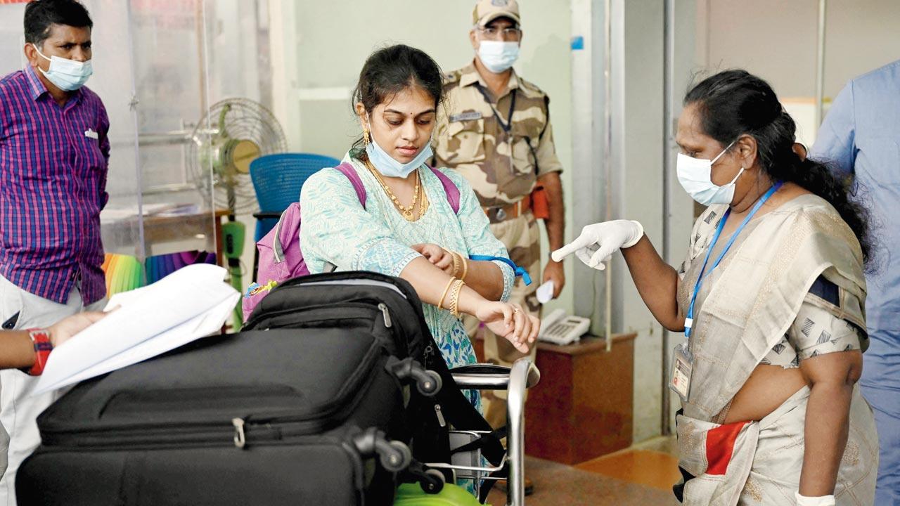 Health workers screen the limbs of passengers arriving on international flights for monkeypox symptoms at Anna International Airport terminal in Chennai last month. Tamil Nadu amped up surveillance after the first case was reported in Kerala early July