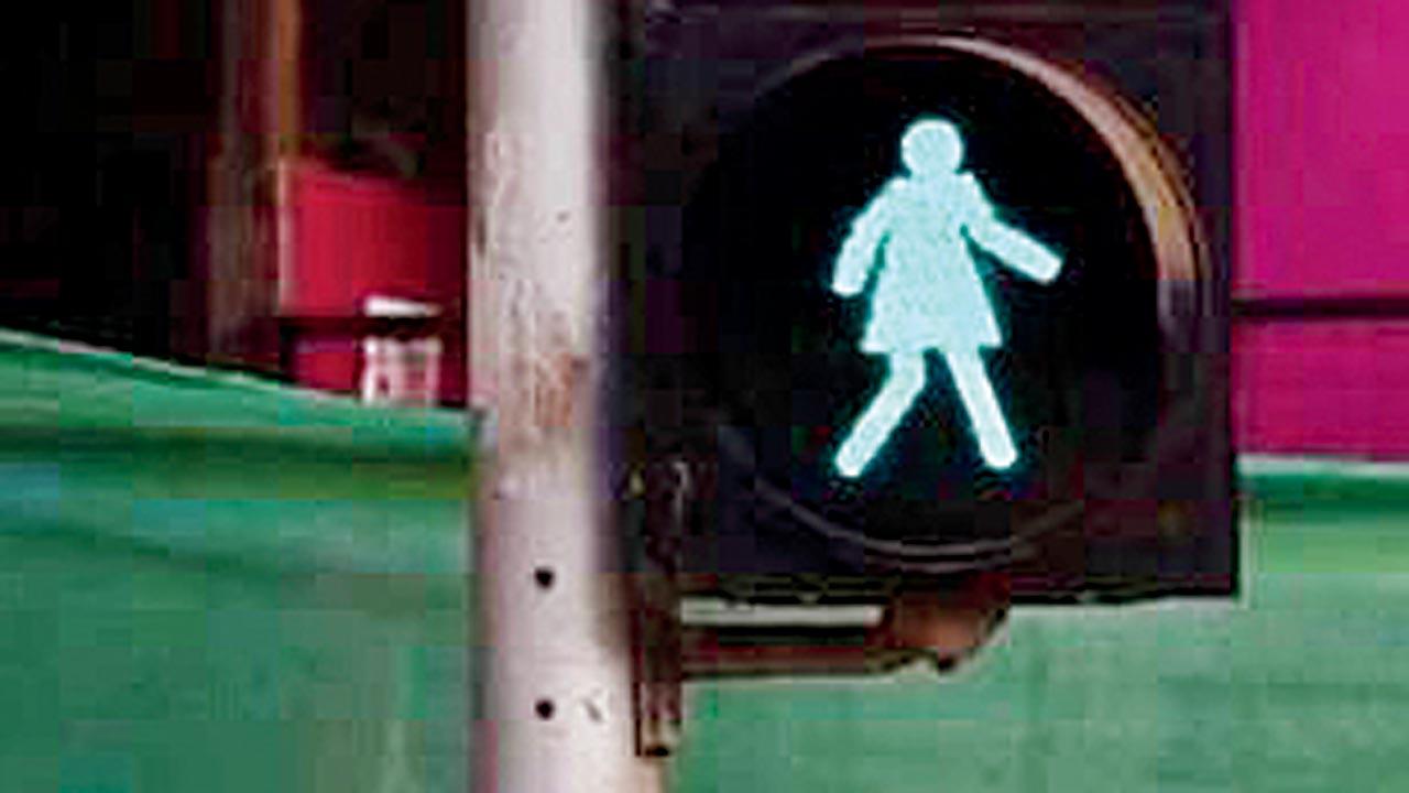 A photo in the post by Tactical Urbanism Mumbai showing a woman’s silhouette on the traffic light 