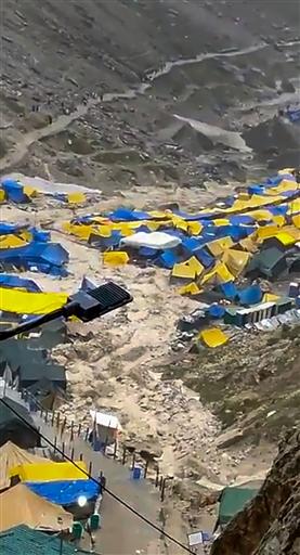 Water flows through a campsite following a cloudburst that hit near the base camp of the holy cave shrine of Amarnath. Pic/PTI