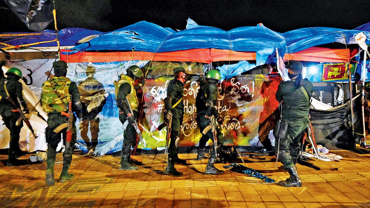 Sri Lankan security forces remove temporary structures set up by anti-government protesters at the site of protest camp in front of the Presidential Secretariat in Colombo on Friday. Pic/AFP