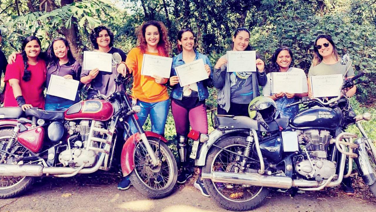 Students pose with course completion certificates