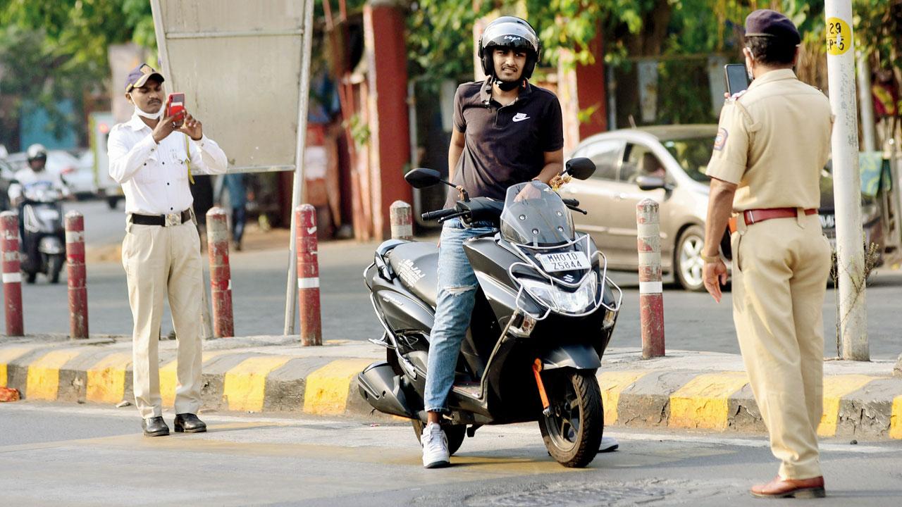A cop stops a biker for wrong-side riding, at Tardeo. File pic