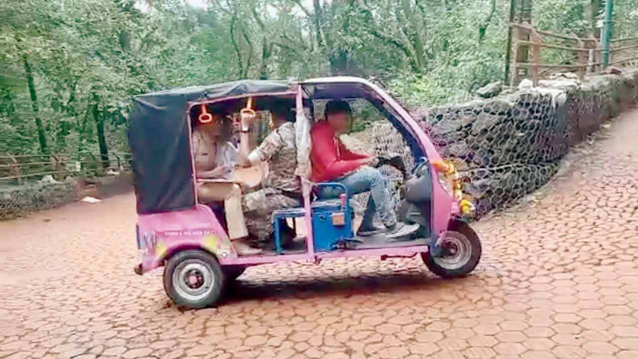 Officers ride an e-rickshaw during a trial