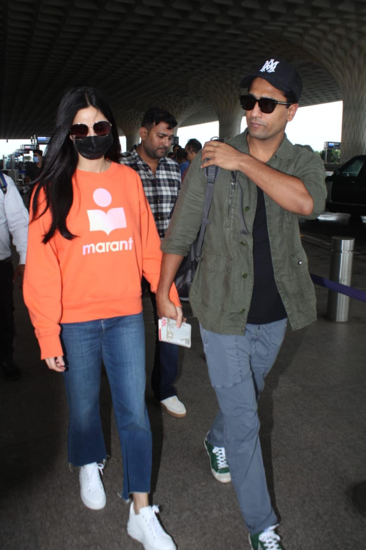 On Friday morning, Katrina Kaif was clicked at the Mumbai airport with her husband Vicky Kaushal as the two headed to the Maldives. Dressed in orange sweatshirt and blue denim, Katrina opted for a casual look for her flight. Vicky, on the other hand, donned a clean-shaven look as he walked towards the airport holding his wife's hand. 
