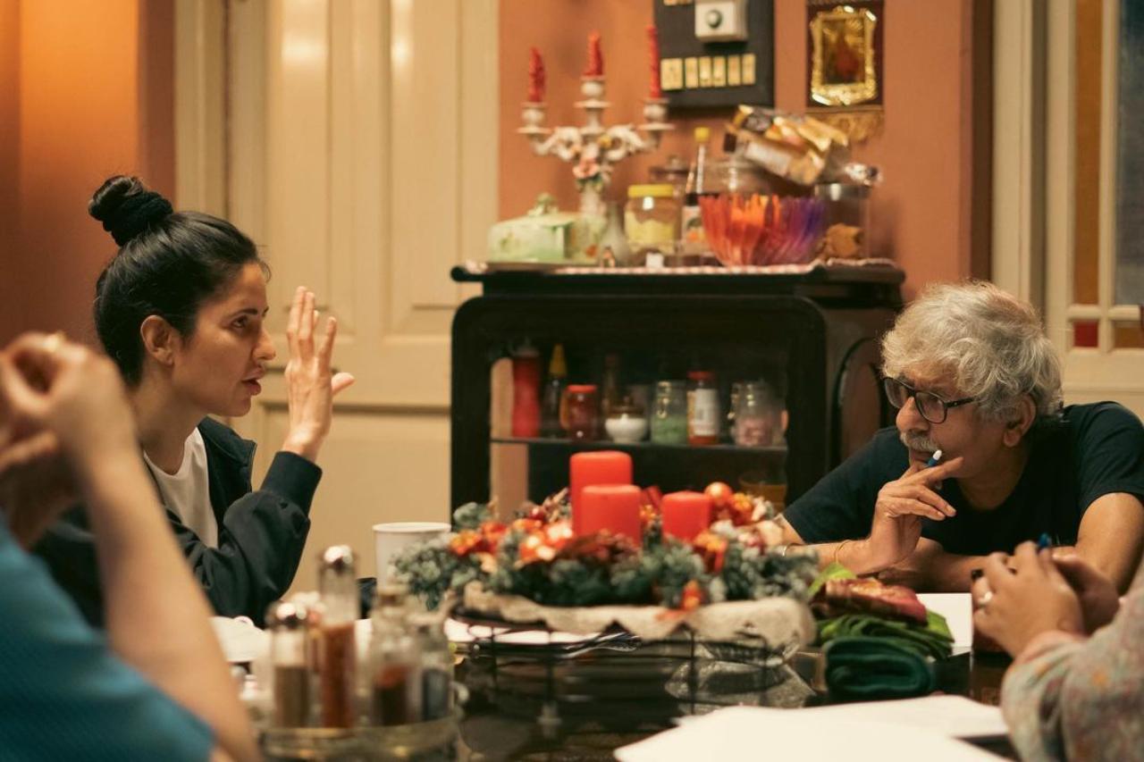 In the first picture, Katrina is seen sitting at a dining table and discussing the scene with director Sriram Raghavan