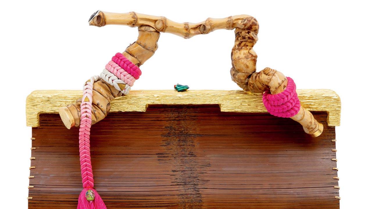 Bamboo mats turned into clutches, with a rare bamboo root as handle
