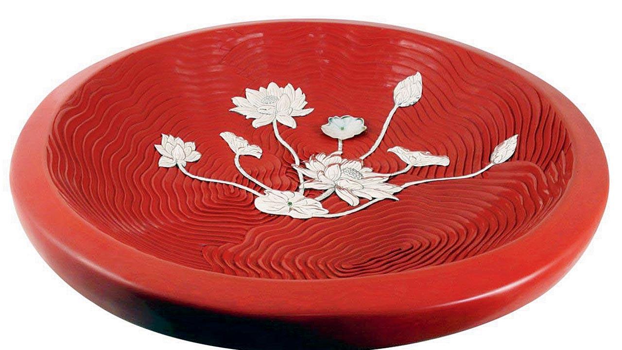 Made in China, this bowl has 60 to 80 layers of lacquer infused with cinnabar for colour 