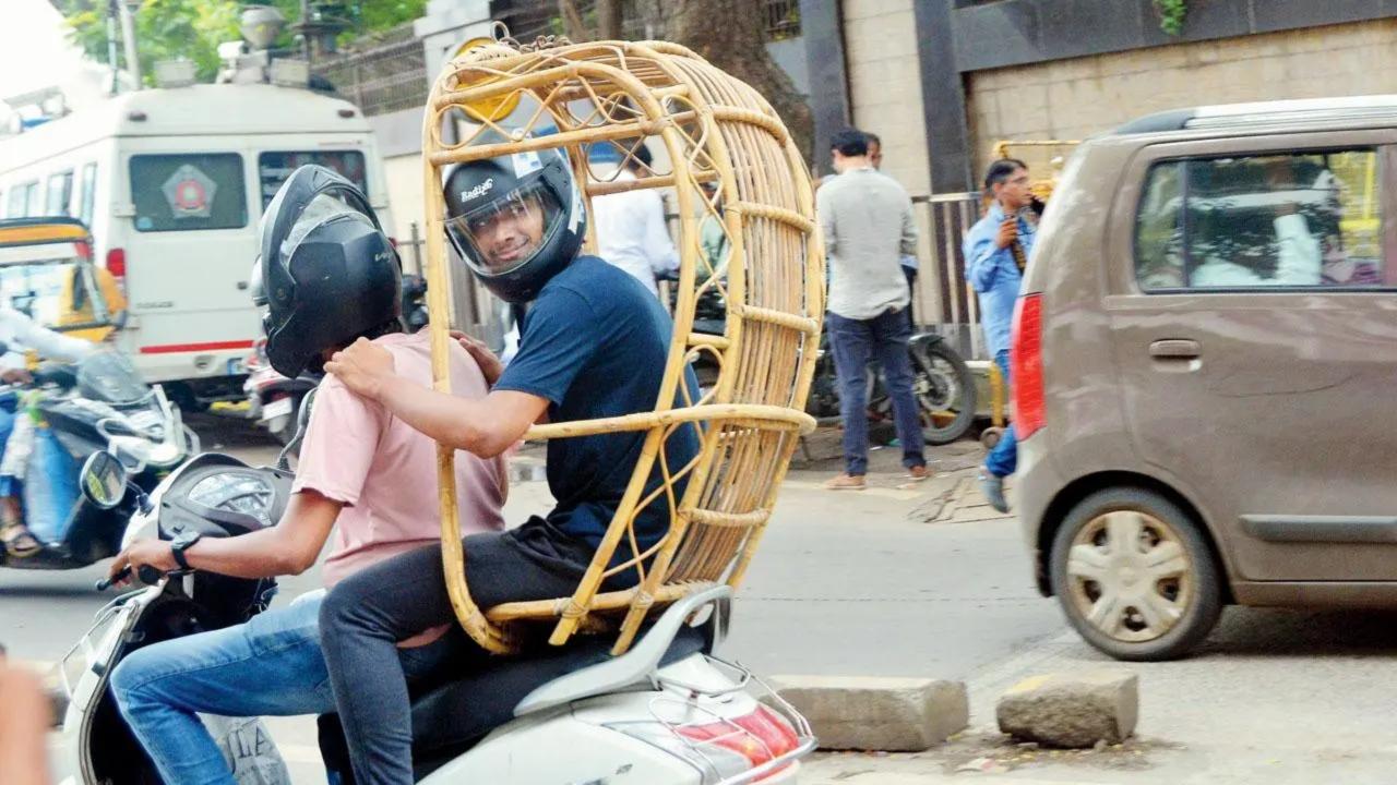 Look, who's got his back: A young man riding pillion on a scooty sits atop a cane swing chair in Kalanagar, Bandra. Pic/Sayyed Sameer Abedi