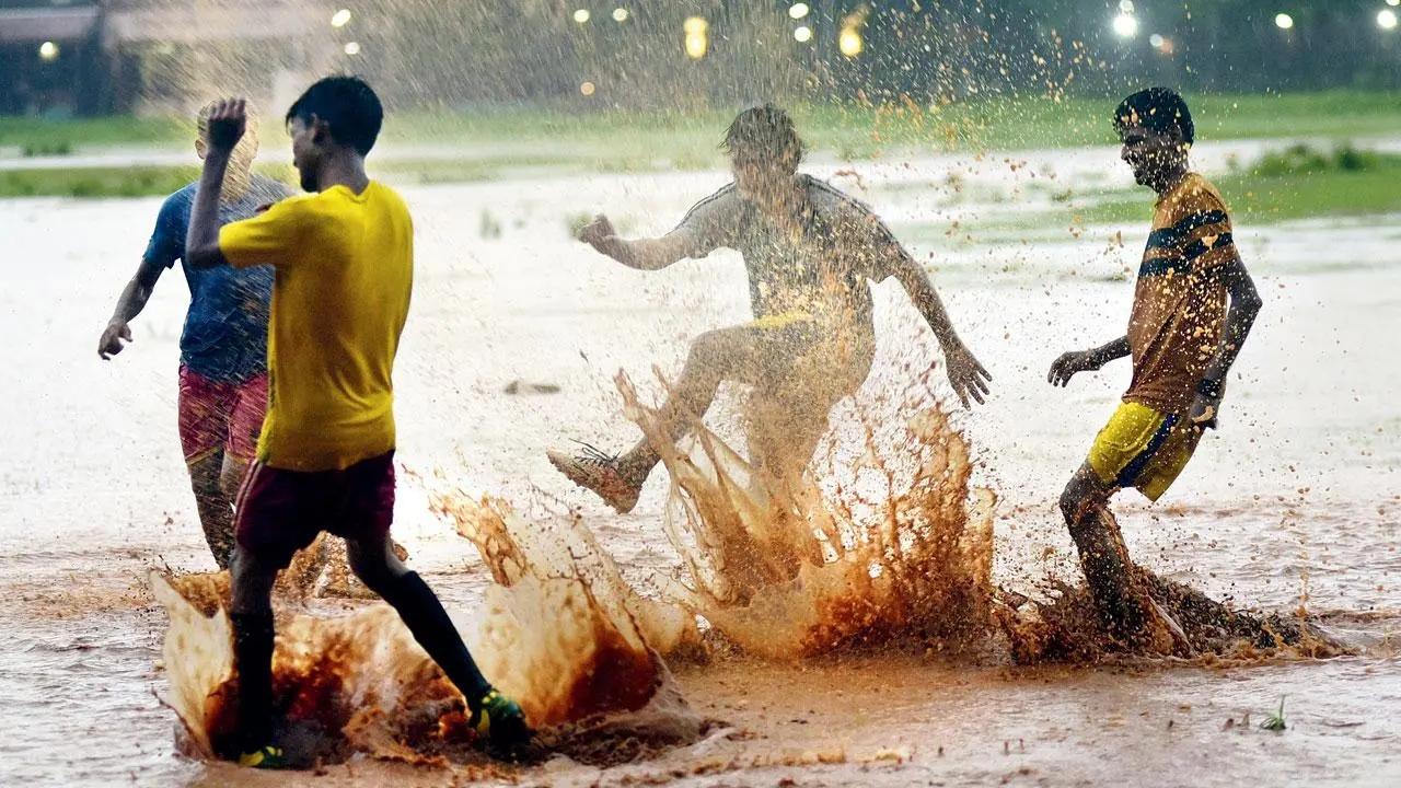 Monsoon kick off: Puddles of rain water didn’t stop a bunch of young boys from enjoying their football at Shivaji Park. Pic/Atul Kamble