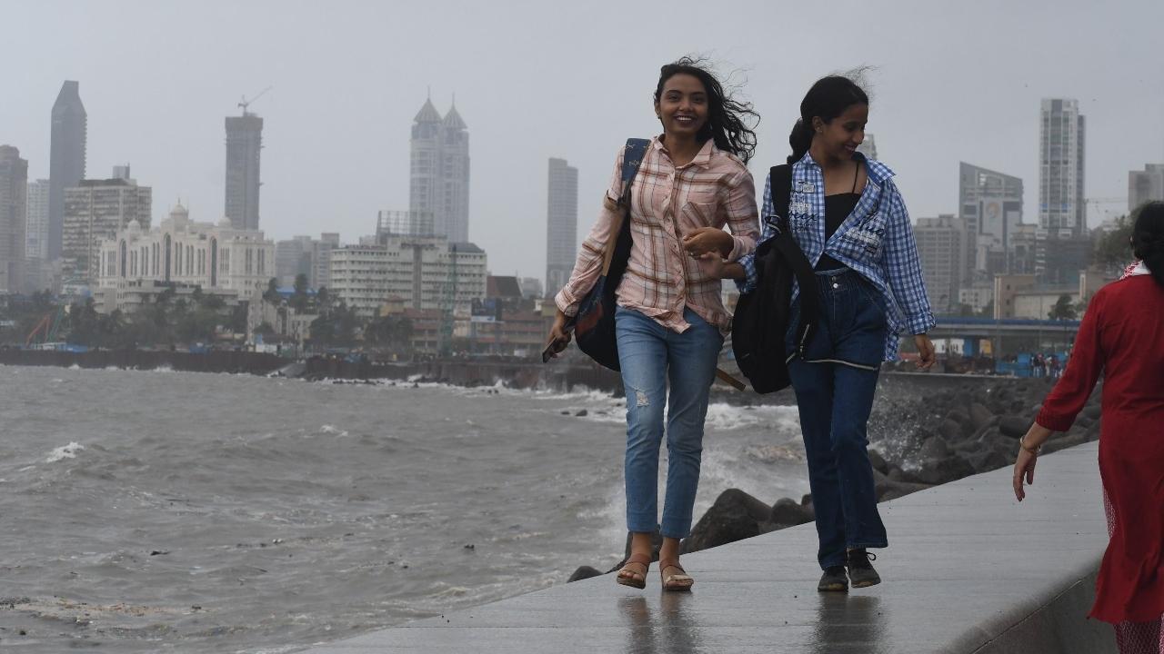 Girls enjoying monsoon weather during high tide in heavy rain at Marin Drive. Pic/Ashish Raje
