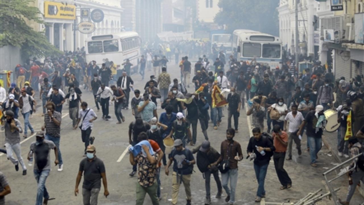 Protestors disperse after police used tear gas to disperse them in Colombo, Sri Lanka. Pic/PTI
