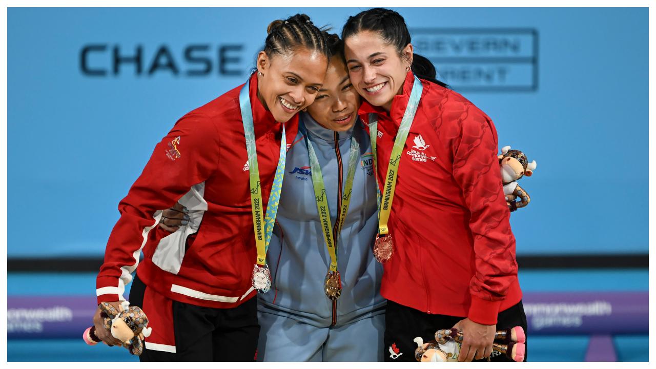 Mirabai Chanu wins Gold medal for India at the Commonwealth Games 2022. Here, she's seen with podium finishers after winning women's 49kg weightlifting category match