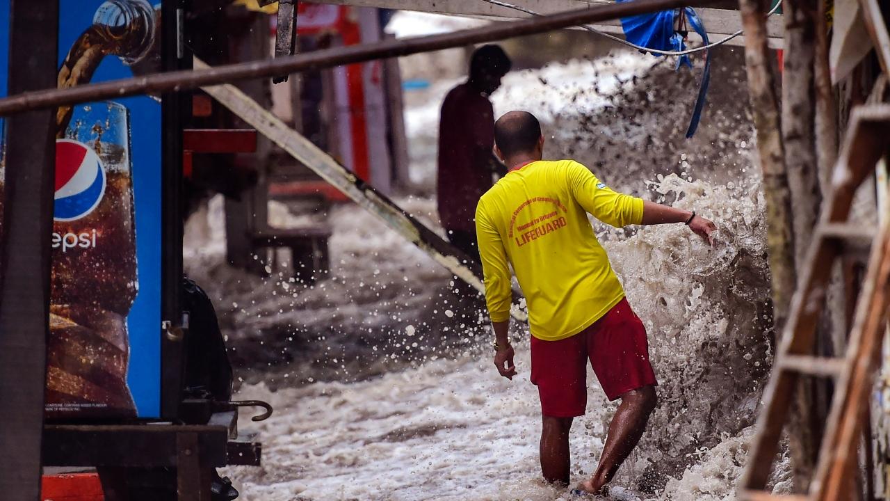 Flooding in front of food stalls during the monsoon season at Dadar beach in Mumbai. Pic/PTI
