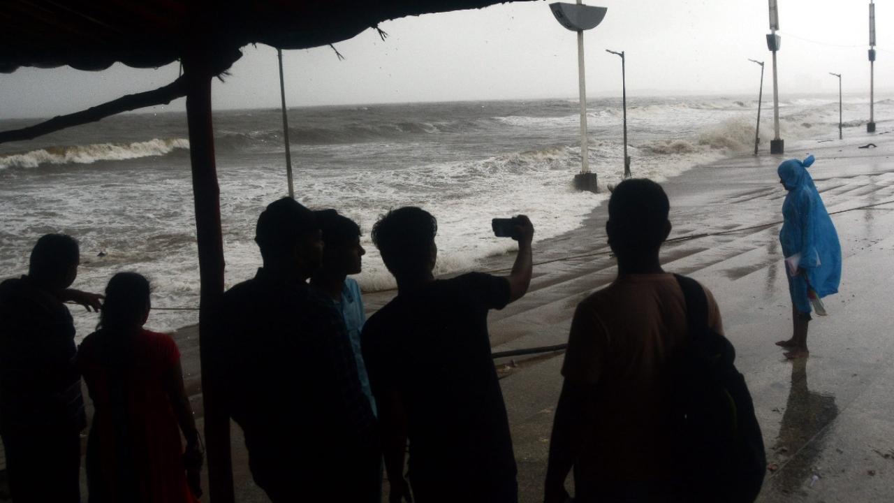 People take selfies as they witness high tide at Juhu Chowpatty. Pic/Sameer Abedi