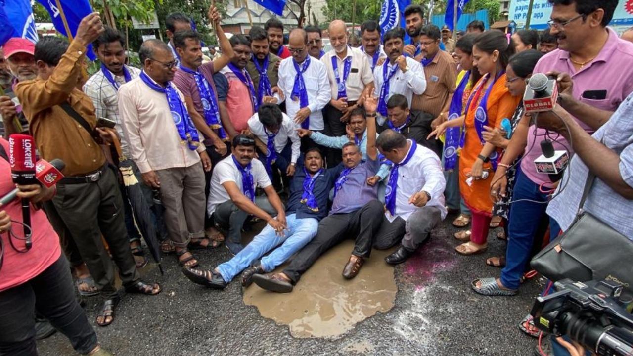 Republican Party of India (RPI) party workers protest over potholes and poor condition of roads, in Mumbai. Pic/PTI