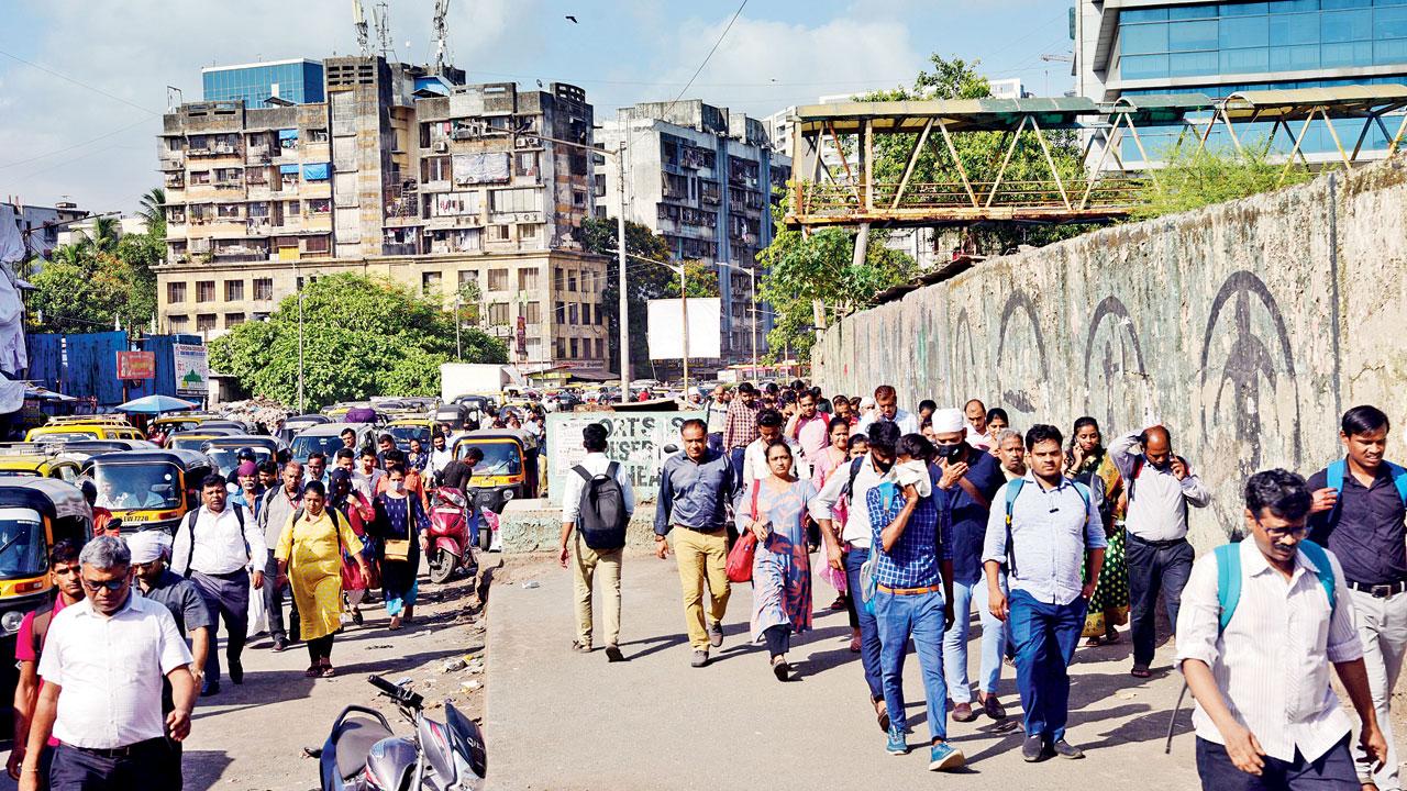 Office-goers at BKC, who were given a half-day off on Tuesday as the PM was to visit the area in the evening, head to Bandra station. Pic/Pradeep Dhivar